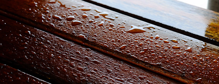Droplet of water on wood and sunlight after rain, high durable material for using long lasting material furniture for safety and save money